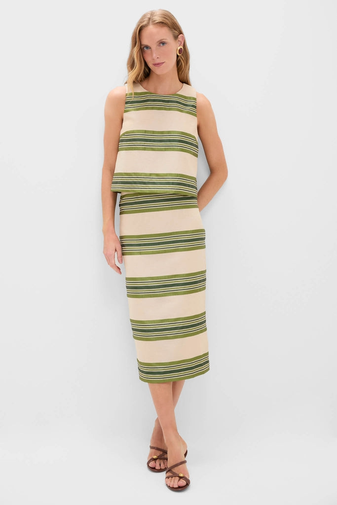 Woman in a classic, effortless Satin Stripe Ellington Skirt ensemble with olive and cream stripes, exuding fun and high-end style, paired with brown strappy sandals.