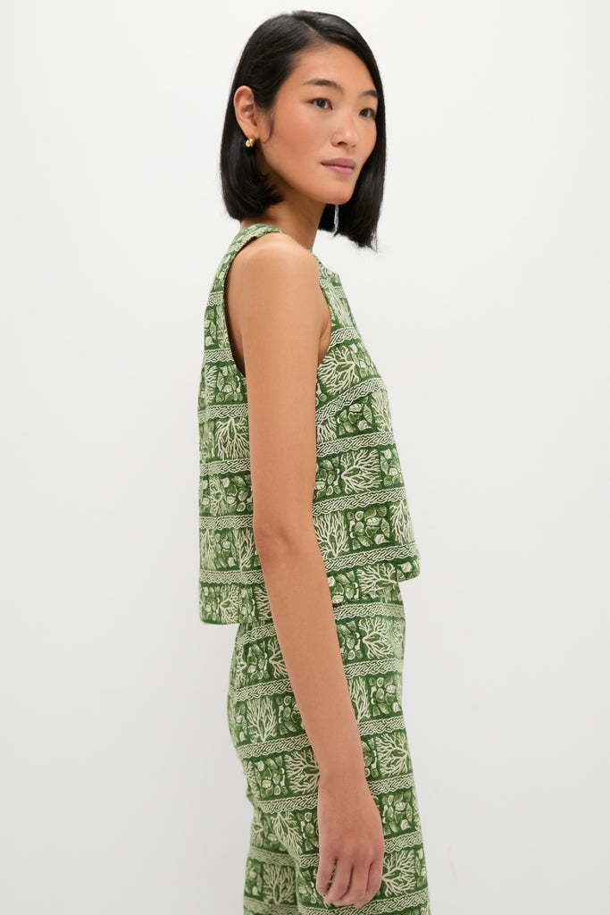 Young woman in profile wearing the classic Cowrie Block Print Keating Top, an effortlessly chic, high-end crop top with a leafy-green pattern, embodying Tuckernuck's fun and confident style.
