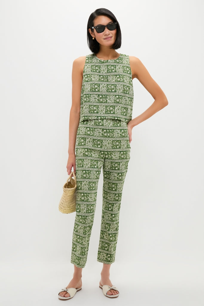 Model wears classic Cowrie Block Print Keating Top and matching pants, complemented by black sunglasses, slide sandals, and a woven tote, embodying an effortless, high-end, fun style.