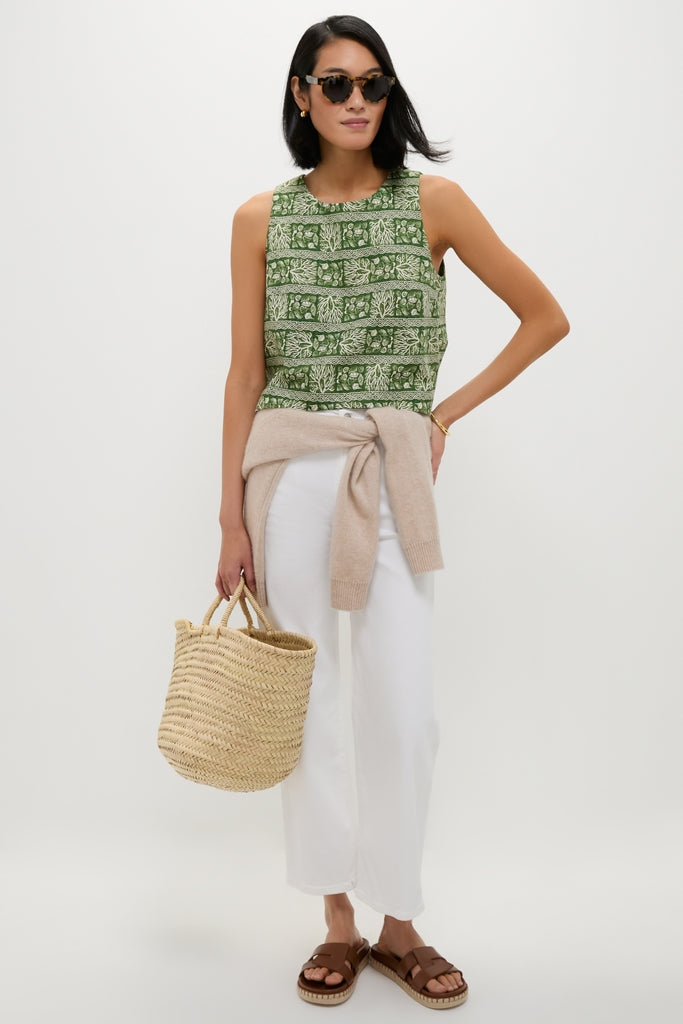Model wearing the Cowrie Block Print Keating Top, featuring a classic, sleeveless design with an effortless botanical print, styled with high-end accessories for a fun, chic look.