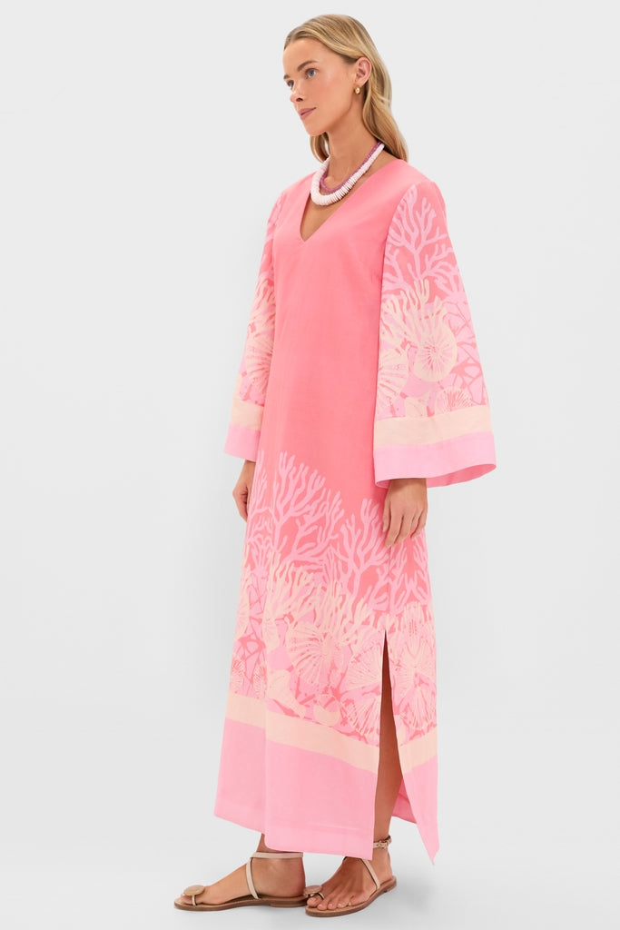 Model wearing the classic Hopewell Coral Printed V-Neck Lorena Caftan with dramatic bell sleeves, a fun coral-reef motif, and an effortless side slit, embodying Tuckernuck's high-end style.