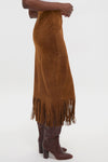 Classic Clove Calf Roughout Suede Midi Skirt with fringe detailing, paired with knee-high leather boots, offers an effortless, high-end style for a fun, confident look.