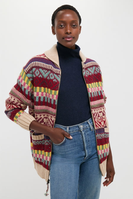 Person wearing a classic, high-end Brick Multi Cotton Wool Blend Sweater with an effortless fair-isle pattern, paired with fun light-wash jeans for a cool, confident style.