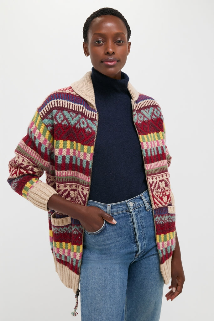 Person wearing a classic, high-end Brick Multi Cotton Wool Blend Sweater with an effortless fair-isle pattern, paired with fun light-wash jeans for a cool, confident style.