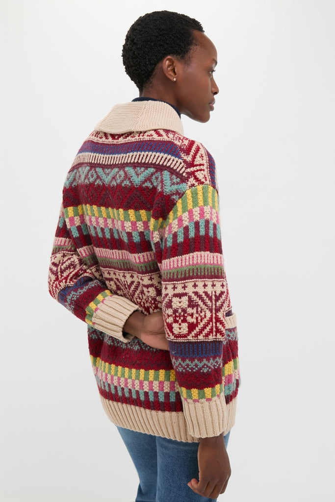 Person showcasing the Brick Multi Cotton Wool Blend Sweater, a classic Fair Isle knit by Polo Ralph Lauren, paired effortlessly with blue jeans, embodying high-end, fun American style.