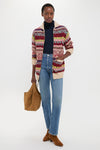 Model wearing a classic, fun Brick Multi Cotton Wool Blend Sweater by Polo Ralph Lauren, paired with effortless jeans and high-end suede booties, embodying Tuckernuck's cool style.