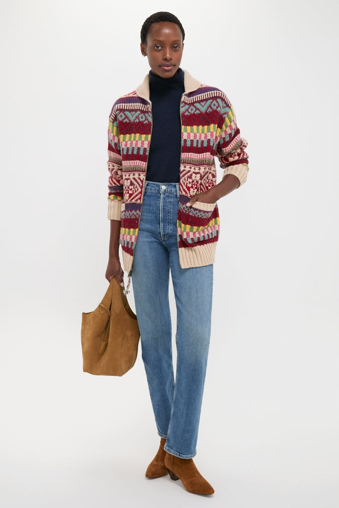 Model wearing a classic, fun Brick Multi Cotton Wool Blend Sweater by Polo Ralph Lauren, paired with effortless jeans and high-end suede booties, embodying Tuckernuck's cool style.
