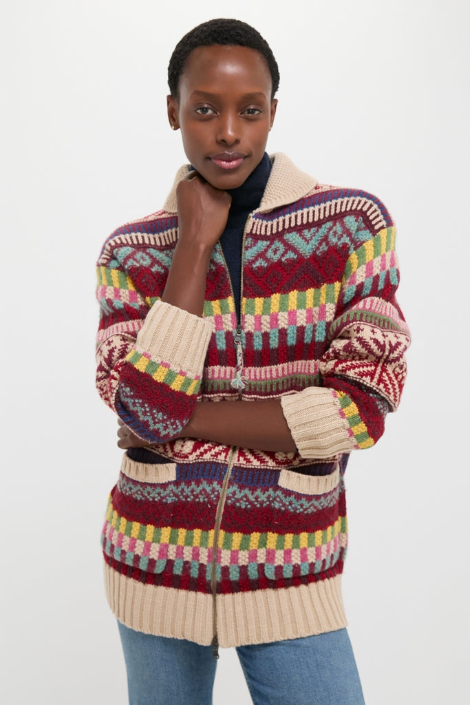 Young woman in a Brick Multi Cotton Wool Blend Sweater, embodying effortless style with classic geometric patterns, paired with jeans for a fun, high-end look.