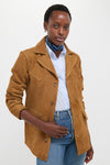A person models the Maple Cow Roughout Suede Jacket, a classic, effortless piece with western flair, featuring notch lapels and distinctive seams, embodying high-end, fun style.