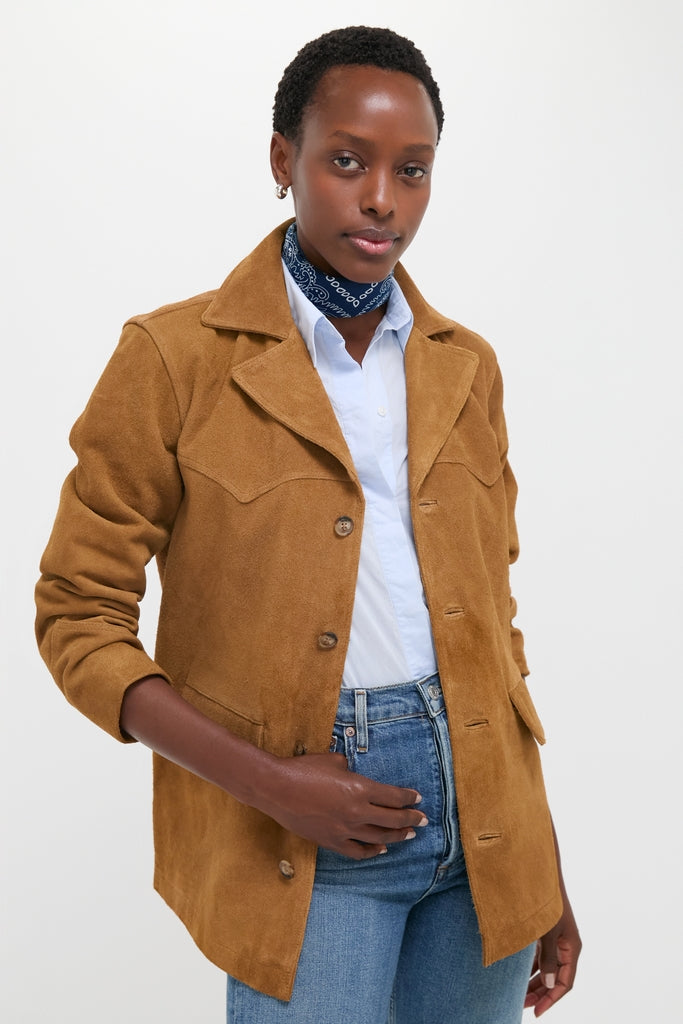 A person models the Maple Cow Roughout Suede Jacket, a classic, effortless piece with western flair, featuring notch lapels and distinctive seams, embodying high-end, fun style.