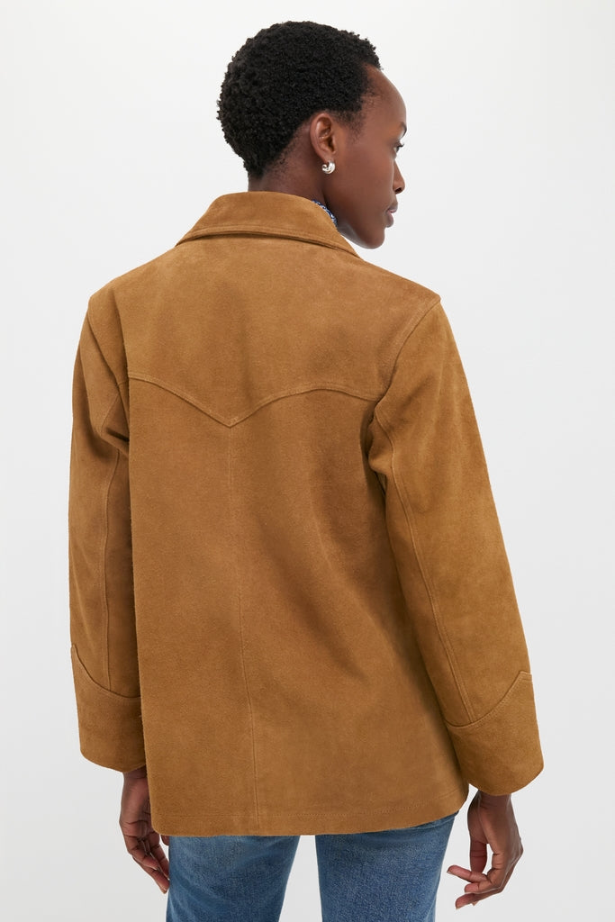 Woman in a classic Maple Cow Roughout Suede Jacket with Western yoke, medium-wash jeans, and silver earrings, embodying effortless, high-end style against a white backdrop.