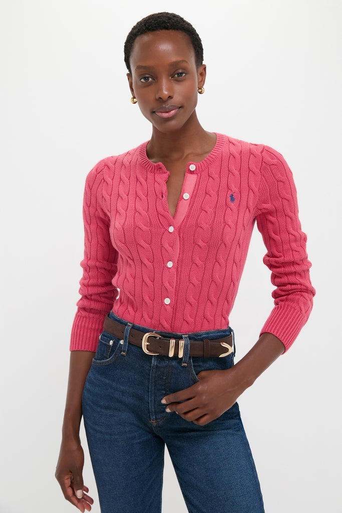 Woman wearing classic, fitted Nantucket Red Cardigan with cable-knit detailing and embroidered logo, paired with high-waisted jeans and a leather belt for an effortless, high-end look.