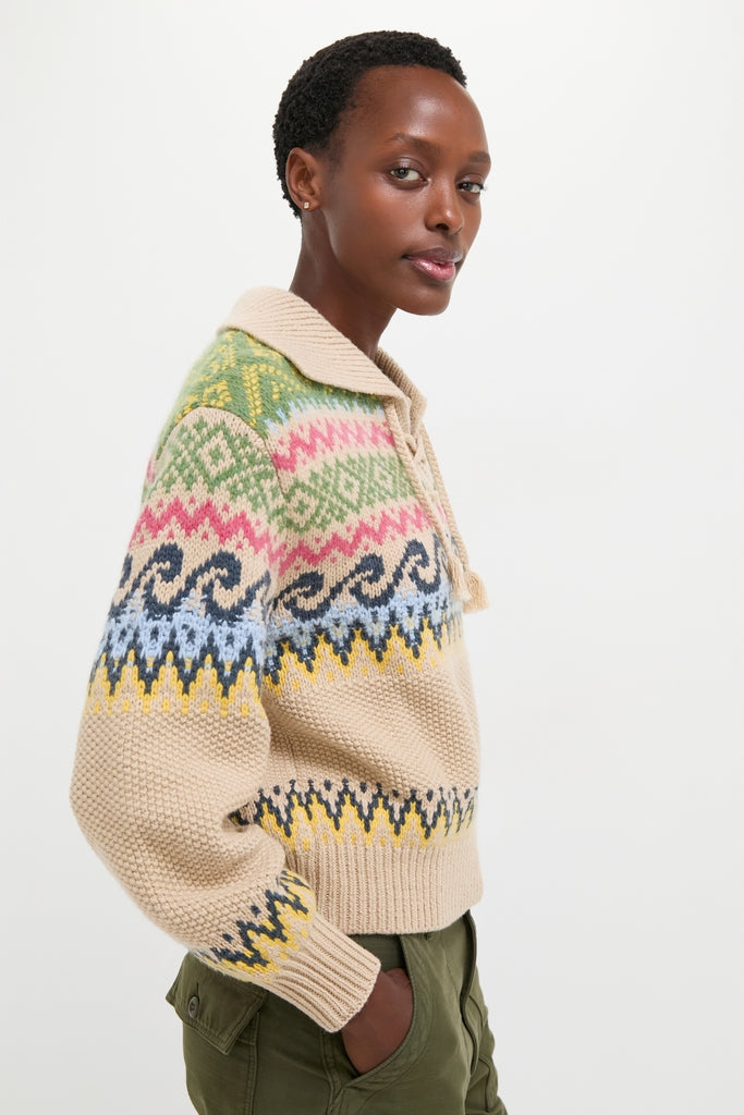 Slim person in profile wearing a Polo Ralph Lauren Tan Multi Cotton Wool Blend Long Sleeve Tie Pullover and olive pants, embodying classic, effortless, high-end style.