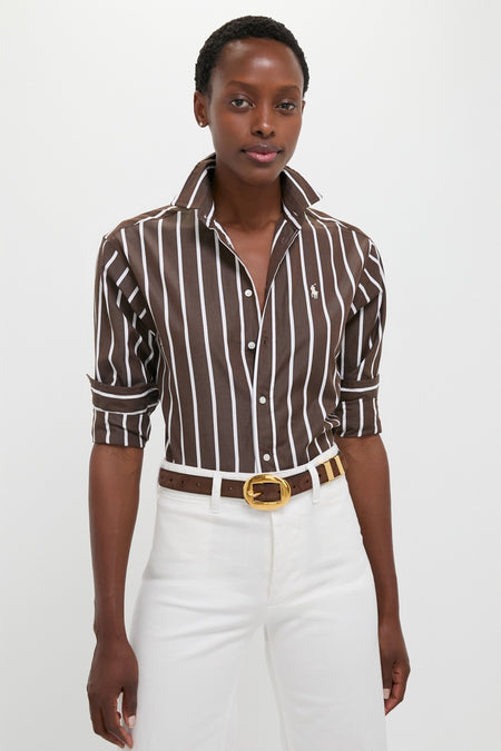 Woman wearing classic Dark Brown and White Stripe Long Sleeve Button Down, effortlessly styled with high-waisted pants and a belt, embodying Tuckernuck's fun, high-end fashion ethos.