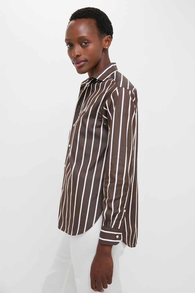 Person wearing a Dark Brown and White Stripe Long Sleeve Button Down with a classic collar, exuding an effortless, high-end style paired with white pants for a fun, minimalist look.
