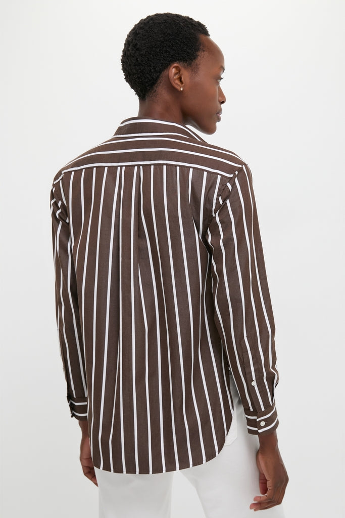 Person wearing a classic Dark Brown and White Stripe Long Sleeve Button Down with button cuffs and a relaxed hem, exuding an effortless, high-end style against a light backdrop.