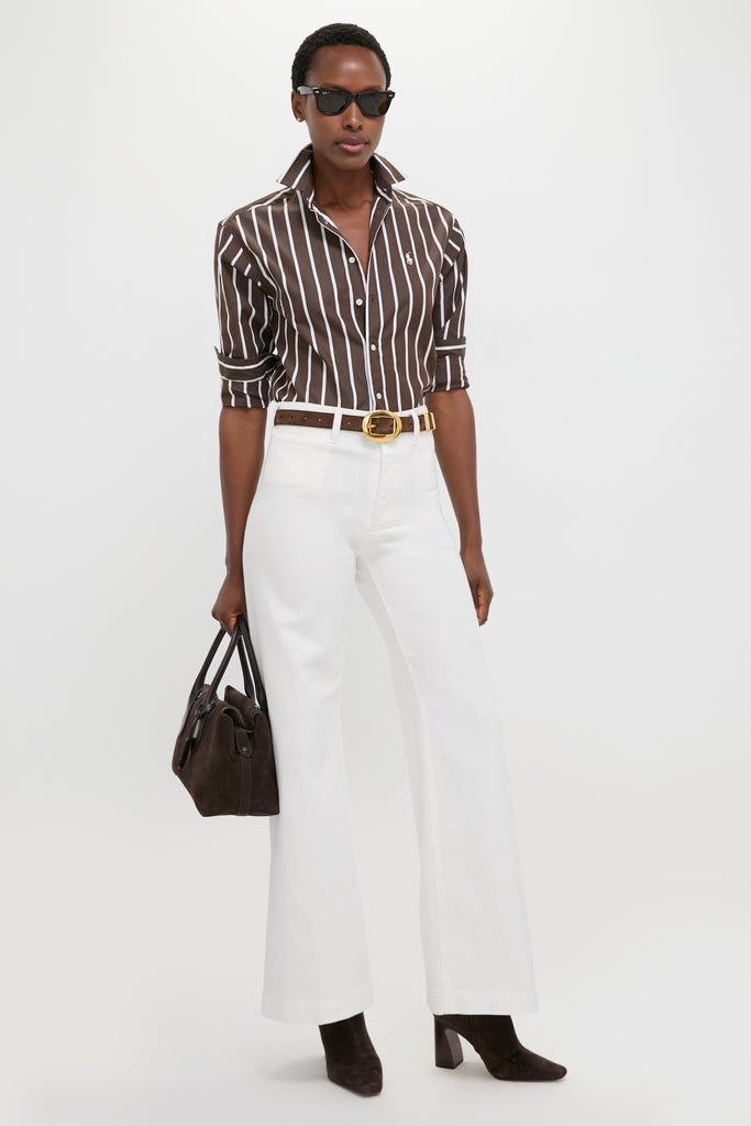 Model in a classic, effortless Dark Brown and White Stripe Long Sleeve Button Down, paired with high-waisted pants and accessories, embodying a fun, high-end style.