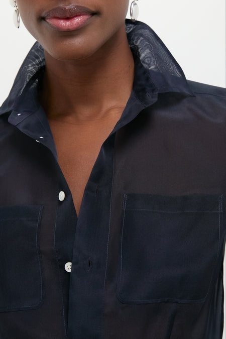 Person wearing the Atlantic Silk Organza Woven Short Sleeve Button Down, showcasing its classic, effortless style with shell buttons and tailored silhouette, exuding high-end fashion appeal.
