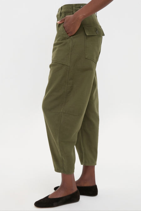 Dark Olive Reverse Sateen Woven Ankle Tapered Pants with patch pockets and a relaxed fit, paired with classic black ballet flats for an effortless, high-end look.