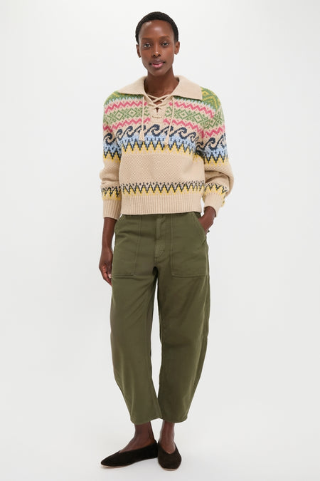 Model in a cream Fair Isle sweater and classic Dark Olive Reverse Sateen Woven Ankle Tapered Pants, embodying an effortless, fun, high-end style.