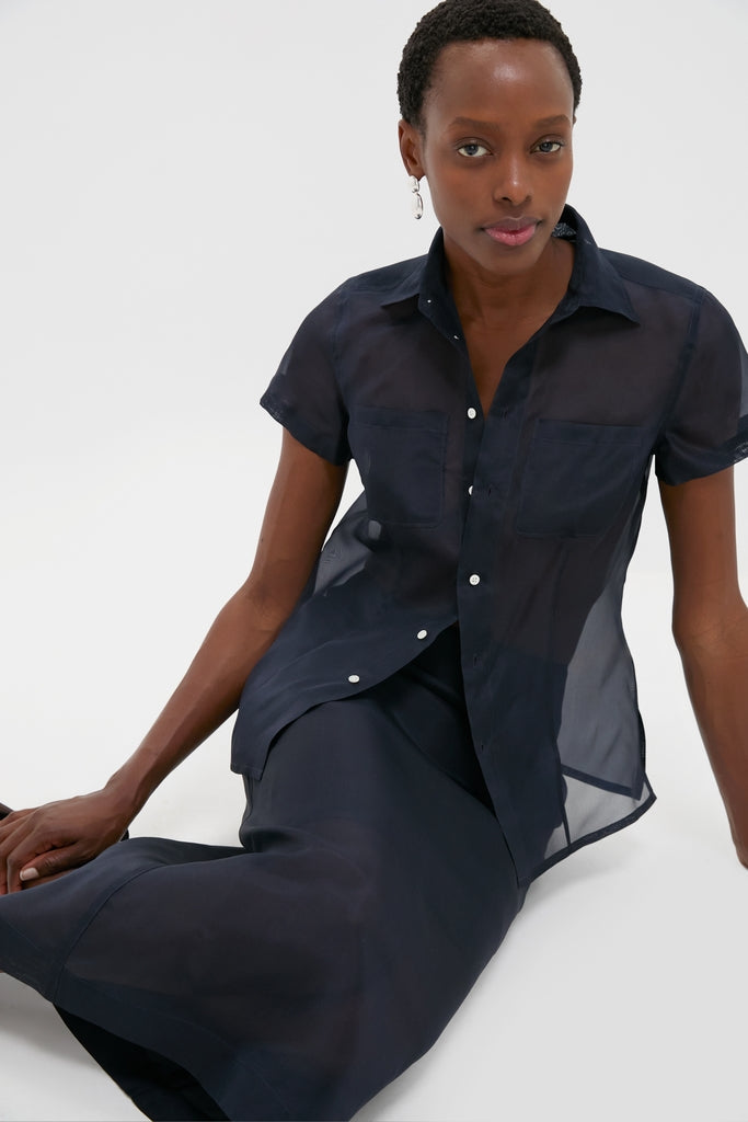 Model wearing the Atlantic Silk Organza Woven Midi Pencil Skirt, showcasing a classic and high-end style with an effortless, fun, and chic sheer design.