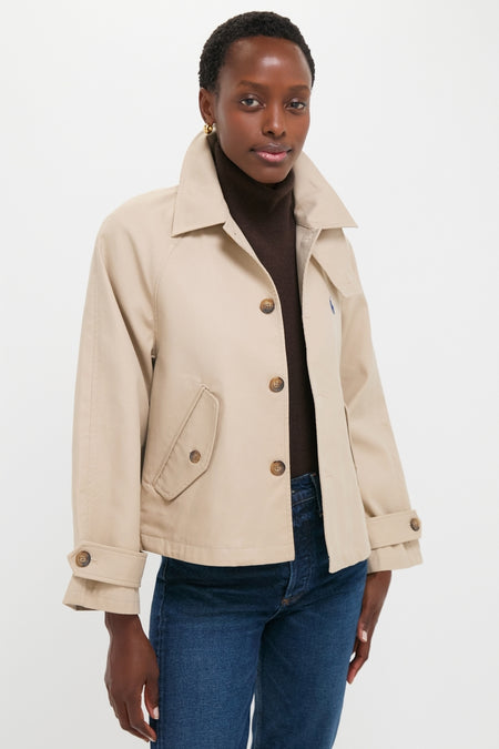 Beige Cotton Double Cloth Woven Jacket layered over a dark brown turtleneck, paired with medium-wash jeans, exudes a classic, effortless, high-end style.