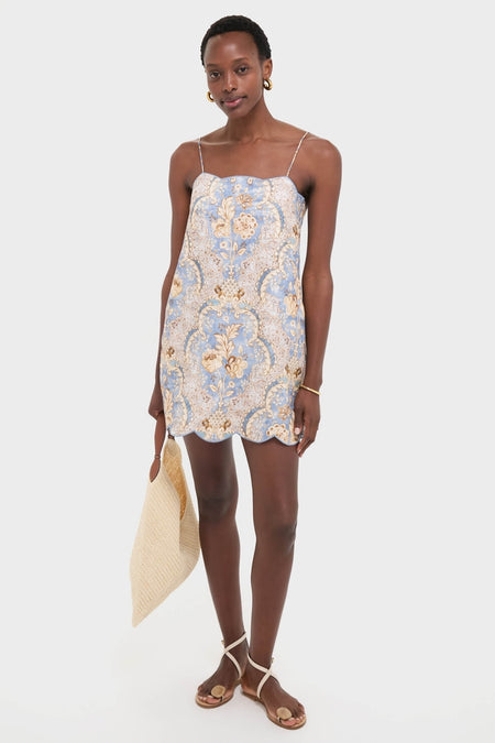 Model holding a classic, high-end Natural Fique Large Origami Shoulder Bag, paired with an effortless floral mini dress and fun, strappy sandals, exuding confident elegance.