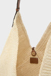 Natural Fique Large Origami Shoulder Bag: A classic, hand-woven straw tote with a narrow leather strap and button closure, embodying effortless style and high-end craftsmanship.