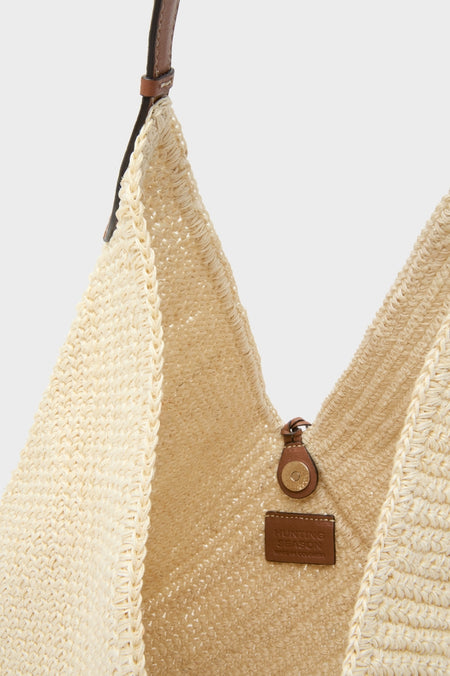 Natural Fique Large Origami Shoulder Bag: A classic, hand-woven straw tote with a narrow leather strap and button closure, embodying effortless style and high-end craftsmanship.