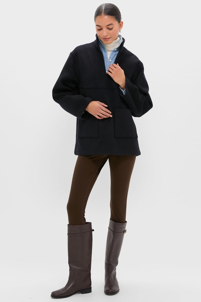 Model wearing the classic Navy Wool Joan Coat with a half-zip collar, styled effortlessly with chic layers and high-end knee-high boots, embodying Tuckernuck's fun, confident vibe.