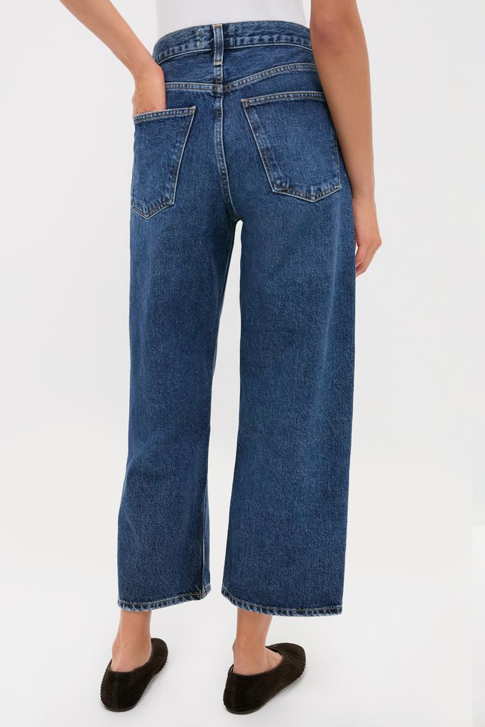 Model wearing Shortwave Arc Jean, classic high-waisted, wide-leg cropped denim with back patch pockets, styled effortlessly with a tucked white top and slip-on flats.