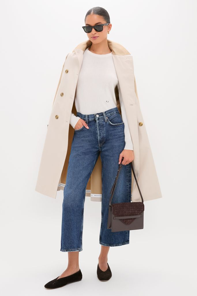 Model showcases classic Shortwave Arc Jean, styled with an effortless white top and trench coat, embodying Tuckernuck's fun, high-end fashion ethos.