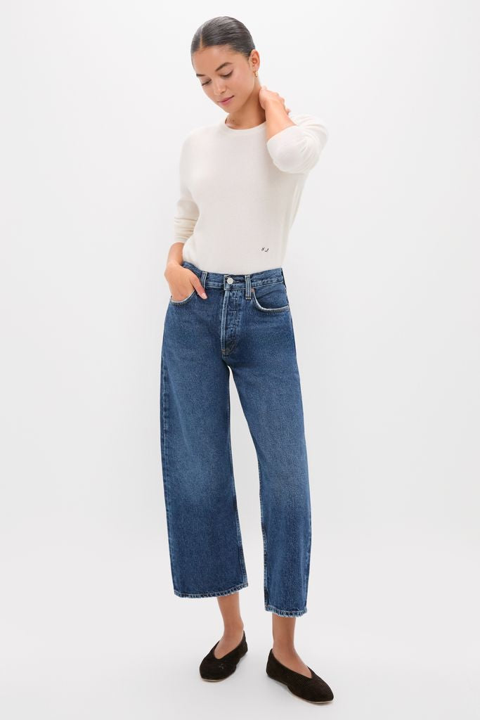 Model wearing classic Shortwave Arc Jean with a fitted cream-white top and black slip-on flats, showcasing an effortless, high-end style perfect for fun, confident dressing.