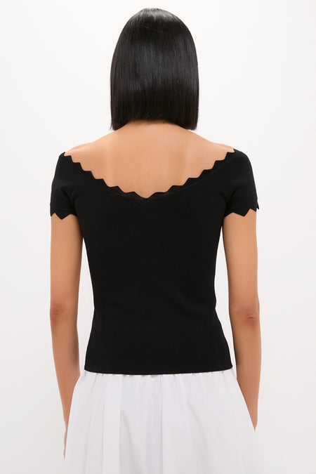 Person wearing a classic Black Off-the-Shoulder Ric Rac Compression Elliston Shirt, showcasing its effortless and fun scalloped neckline and chic slim fit.