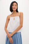 Young woman modeling the White Cotton Poplin Mandi Top with a square neck and spaghetti straps, embodying a classic and effortless style with high-end appeal.
