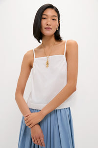 Young woman modeling the White Cotton Poplin Mandi Top with a square neck and spaghetti straps, embodying a classic and effortless style with high-end appeal.