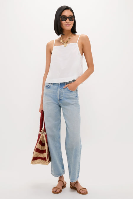 Woman wearing the classic White Cotton Poplin Mandi Top with light-wash jeans, accessorized with a chunky gold necklace, offering an effortless, high-end look perfect for fun summer outings.
