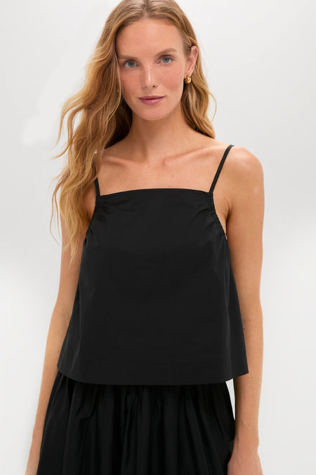 Woman wears the Black Cotton Poplin Mandi Top, a classic, effortless camisole with spaghetti straps, perfect for a high-end, fun look.