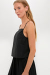 Woman in Black Cotton Poplin Mandi Top, showcasing a classic, effortless look with thin straps and minimalist design, embodying Tuckernuck's high-end, fun, and confident style.
