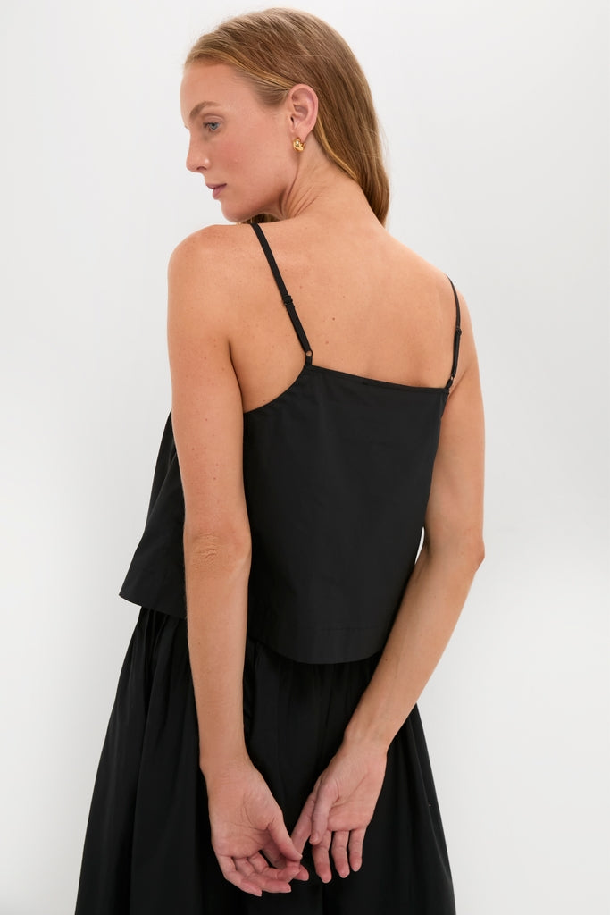 Woman models the Black Cotton Poplin Mandi Top, a classic, high-end sleeveless camisole with adjustable straps, embodying effortless and fun style.