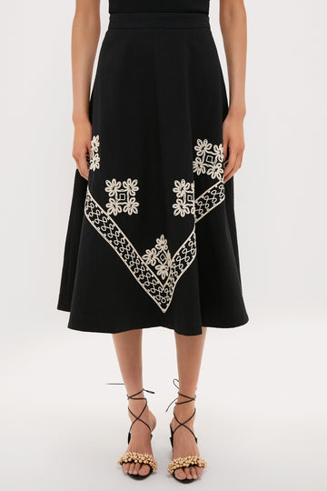 Soutache Cotton Andrea Circle Skirt exudes classic elegance with its effortless A-line design, featuring fun cream-white embroidery and paired with high-end, gold-embellished sandals.