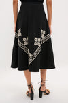 Soutache Cotton Andrea Circle Skirt with geometric and floral embroidery, exudes classic elegance. Paired with fun, high-end lace-up sandals, it offers an effortless, chic look.