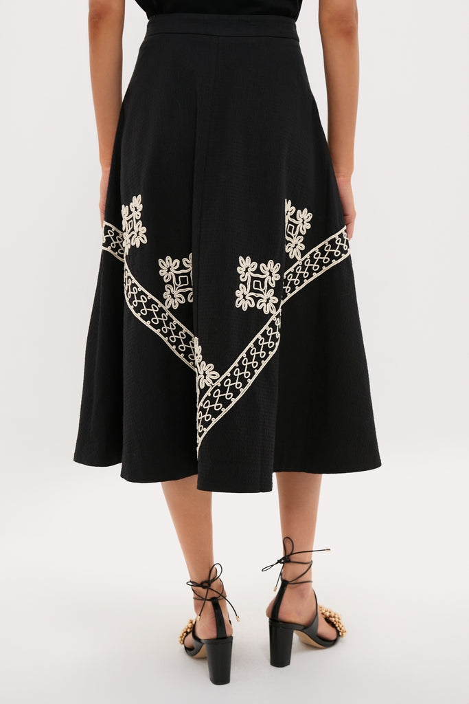 Soutache Cotton Andrea Circle Skirt with geometric and floral embroidery, exudes classic elegance. Paired with fun, high-end lace-up sandals, it offers an effortless, chic look.