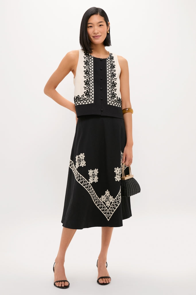 Model wearing the classic Soutache Cotton Andrea Circle Skirt, styled with an effortless embroidered vest and fun open-toe heels, exuding a high-end, confident look.