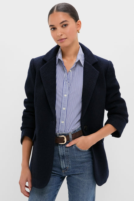 Young woman models the Navy Boucle Leo Blazer, a classic, effortless piece with a modern edge, showcasing its oversized fit and peak lapels for a high-end, fun style.