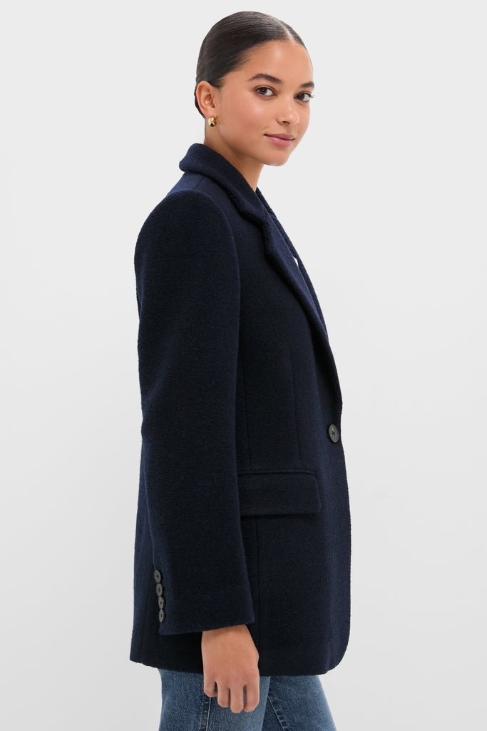 Young woman models the Navy Boucle Leo Blazer with peak lapels and oversized fit, paired with jeans for a classic, effortless, and high-end look.