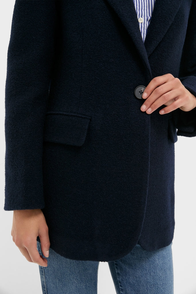 Navy Boucle Leo Blazer, a classic with peak lapels and oversized fit, over a striped shirt, exuding effortless high-end style with a fun, modern twist.