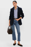 Woman in navy boucle Leo Blazer, oversized fit with peak lapels, styled effortlessly over striped shirt and jeans, embodying classic, high-end, and fun Tuckernuck style.