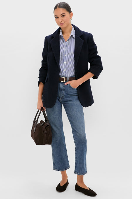 Woman in navy boucle Leo Blazer, oversized fit with peak lapels, styled effortlessly over striped shirt and jeans, embodying classic, high-end, and fun Tuckernuck style.