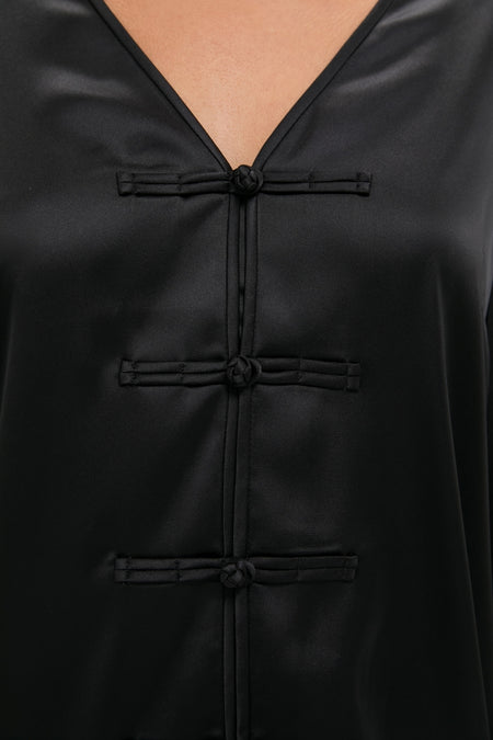 Black Satin Tatiana Dress, featuring an effortless V-neck and classic frog closures, epitomizes fun, high-end style for day-to-night elegance.